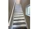 Staircase with stylish gray and white vinyl flooring and natural light at 2404 Cassell St, Tampa, FL 33605