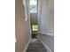 Clean staircase with gray and white vinyl flooring ascending to the upper level at 2404 Cassell St, Tampa, FL 33605
