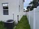Side yard of house with white vinyl fence and air conditioning condenser visible at 2404 Cassell St, Tampa, FL 33605