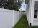 White vinyl privacy fence lining the side yard with grass at 2404 Cassell St, Tampa, FL 33605