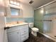 Bright bathroom with updated vanity, framed mirror, shower and pebble style flooring at 2459 Columbia Dr # 39, Clearwater, FL 33763