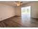Spacious bedroom features wood look flooring and access to an enclosed sun room at 2459 Columbia Dr # 39, Clearwater, FL 33763