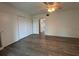 Bedroom with a closet, neutral walls, modern ceiling fan, and wood look flooring at 2459 Columbia Dr # 39, Clearwater, FL 33763