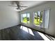 This bedroom offers natural light, wood-look floors, and views of the well-manicured backyard at 2459 Columbia Dr # 39, Clearwater, FL 33763