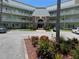 Exterior shot of a multi-story building featuring meticulous landscaping and ample parking at 2459 Columbia Dr # 39, Clearwater, FL 33763