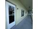 View of unit 39's front door, framed by large windows and a glimpse of the building's architecture at 2459 Columbia Dr # 39, Clearwater, FL 33763