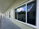 Exterior view with large sliding glass windows and muted green siding, showcasing the building's design at 2459 Columbia Dr # 39, Clearwater, FL 33763