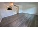 Spacious living room with light gray wood floors and a view into the kitchen, highlighting the open layout at 2459 Columbia Dr # 39, Clearwater, FL 33763
