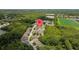 Overhead shot of homes in a community near a calm pond surrounded by trees at 2537 Stanhope Dr, New Port Richey, FL 34655