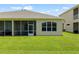Beautiful backyard featuring a covered screened lanai and a lush green lawn at 2537 Stanhope Dr, New Port Richey, FL 34655