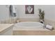 Tranquil bathroom with a separate tub accented with stylish decor, creating a peaceful retreat at 2537 Stanhope Dr, New Port Richey, FL 34655