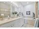 Luxurious bathroom with double sinks, white cabinets, and a separate soaking tub for relaxation at 2537 Stanhope Dr, New Port Richey, FL 34655