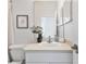 Bright bathroom featuring a toilet, and a single sink vanity with white cabinets and a decorative vase at 2537 Stanhope Dr, New Port Richey, FL 34655