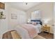 Inviting bedroom with plush bedding, wood floors, and natural light, perfect for relaxation and comfort at 2537 Stanhope Dr, New Port Richey, FL 34655
