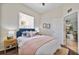 Cozy bedroom with a blue headboard, layered bedding, and wood-look floors for a comfortable space at 2537 Stanhope Dr, New Port Richey, FL 34655
