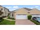 Inviting home exterior featuring a two-car garage, manicured lawn, and well-maintained landscaping at 2537 Stanhope Dr, New Port Richey, FL 34655