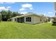 A view of the exterior showing the screened in lanai and large backyard at 2537 Stanhope Dr, New Port Richey, FL 34655
