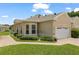 Exterior view showcasing a well-manicured lawn, brick walkway, and lush landscaping surrounding the home at 2537 Stanhope Dr, New Port Richey, FL 34655