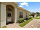 Charming home entrance featuring a decorative wreath, arched doorway, and beautiful brick walkway at 2537 Stanhope Dr, New Port Richey, FL 34655