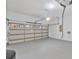 Clean garage featuring a multi-panel garage door, grey epoxy flooring, and utility panel at 2537 Stanhope Dr, New Port Richey, FL 34655