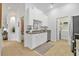 A convenient kitchenette with white cabinets, sink, and appliances, offering functionality and style at 2537 Stanhope Dr, New Port Richey, FL 34655