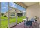 Enclosed lanai with brick flooring, patio furniture, and view of backyard at 2537 Stanhope Dr, New Port Richey, FL 34655