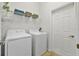 Functional laundry room with appliances, storage shelves and tile floors at 2537 Stanhope Dr, New Port Richey, FL 34655