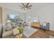 Bright living room with comfortable seating, wood floors, and plenty of natural light creating an inviting space at 2537 Stanhope Dr, New Port Richey, FL 34655