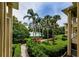 Scenic exterior view showcases the lush landscaping and serene lake views from the condo at 2690 Coral Landings Blvd # 122, Palm Harbor, FL 34684