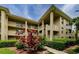 Attractive condo building featuring well-maintained landscaping and multi-level balconies at 2690 Coral Landings Blvd # 122, Palm Harbor, FL 34684