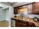 Updated kitchen with stainless steel appliances, stylish backsplash, and dark cabinetry at 2690 Coral Landings Blvd # 122, Palm Harbor, FL 34684