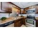 Well-equipped kitchen featuring stainless steel appliances and attractive backsplash at 2690 Coral Landings Blvd # 122, Palm Harbor, FL 34684