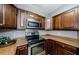 A kitchen featuring stainless steel appliances and dark wood cabinetry at 2690 Coral Landings Blvd # 122, Palm Harbor, FL 34684