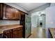 Kitchen area featuring stainless steel appliances and dark wood cabinetry at 2690 Coral Landings Blvd # 122, Palm Harbor, FL 34684