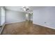 Spacious living room featuring neutral paint, tile floors, and multiple ceiling fans at 2690 Coral Landings Blvd # 122, Palm Harbor, FL 34684