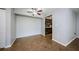 Inviting living room featuring tiled floors and a ceiling fan, seamlessly connecting to the kitchen at 2690 Coral Landings Blvd # 122, Palm Harbor, FL 34684