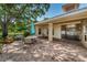 Covered patio with a round table and chairs outside of community clubhouse at 2690 Coral Landings Blvd # 122, Palm Harbor, FL 34684