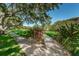 Sidewalk surrounded by lush greenery and landscaping provides a scenic walking path through the community at 2690 Coral Landings Blvd # 122, Palm Harbor, FL 34684