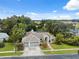 Expansive home with manicured lawn, mature trees, three-car garage and screened in pool at 3037 Crest Dr, Clearwater, FL 33759