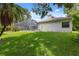 Beautiful backyard showcasing the screened pool enclosure and well-maintained lawn at 3037 Crest Dr, Clearwater, FL 33759