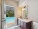 Bright bathroom with granite countertop, wood vanity, and a pool view at 3037 Crest Dr, Clearwater, FL 33759