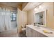 Bathroom features a single sink vanity and shower-tub combination with a white shower curtain at 3037 Crest Dr, Clearwater, FL 33759