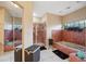 Well-lit bathroom showcases custom tile, a glass shower, a garden window, and a soaking tub at 3037 Crest Dr, Clearwater, FL 33759