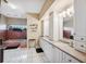 Bright bathroom has a double sink vanity, granite countertops, custom tile, and a soaking tub at 3037 Crest Dr, Clearwater, FL 33759
