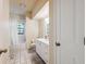 Bathroom features a double sink vanity and shower-tub combination with a white shower curtain at 3037 Crest Dr, Clearwater, FL 33759