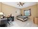 Bright bedroom features tile flooring, a ceiling fan, and a window for natural light at 3037 Crest Dr, Clearwater, FL 33759
