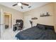 Cozy bedroom with an oversized window, ceiling fan, and neutral wall paint at 3037 Crest Dr, Clearwater, FL 33759