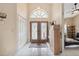 Bright foyer featuring double doors with decorative glass and tile flooring and high ceiling at 3037 Crest Dr, Clearwater, FL 33759