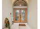 Elegant double front doors with decorative glass panels, enhanced by an arched transom window at 3037 Crest Dr, Clearwater, FL 33759