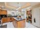 Bright kitchen features an island, black countertops, stainless steel appliances, and white tile flooring at 3037 Crest Dr, Clearwater, FL 33759